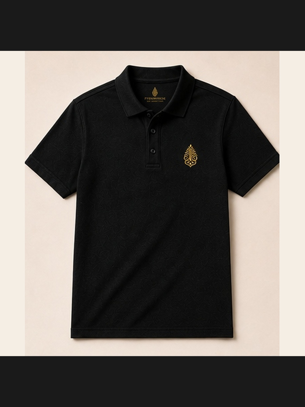 Pyramidion Crest Polo in black with the gold Pyramidion crest at the chest, photographed without a model.
