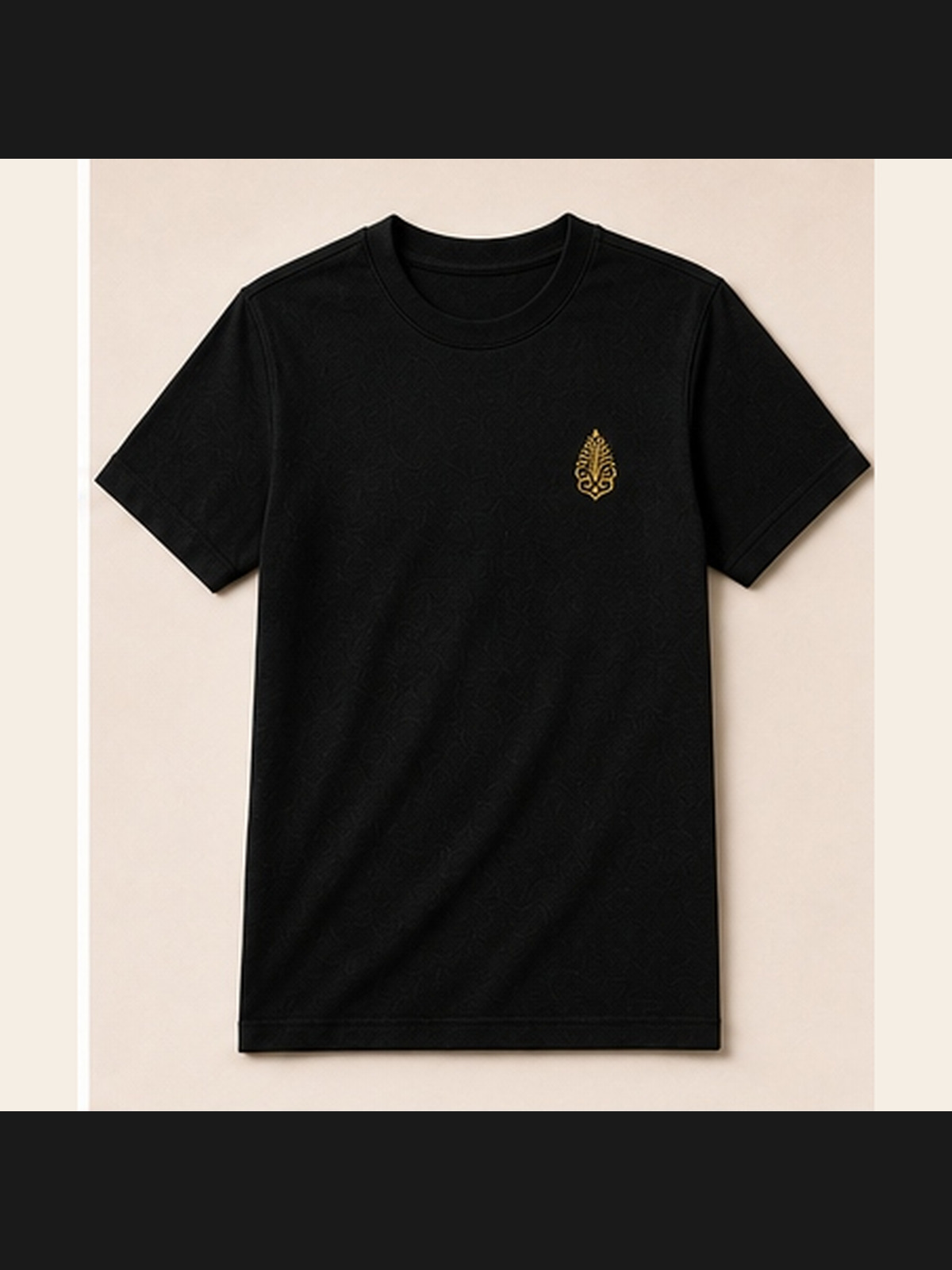 Pyramidion Crest Tee in black with the gold Pyramidion crest at the chest, photographed without a model.